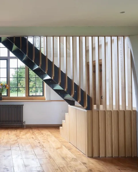 Bespoke timber stair balustrade and flooring detail in a finished home renovation