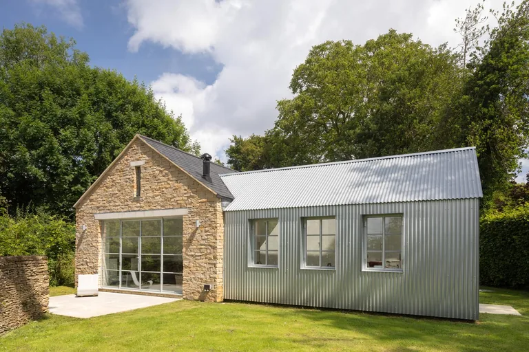 Contemporary grey extension and traditional stonework on a completed Gloucestershire home