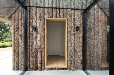 Timber cladding and recessed doorway detail on the completed project